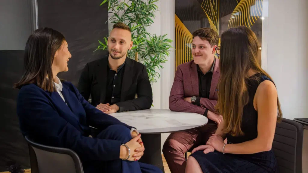 Dream Writers team members having a business discussion in the office