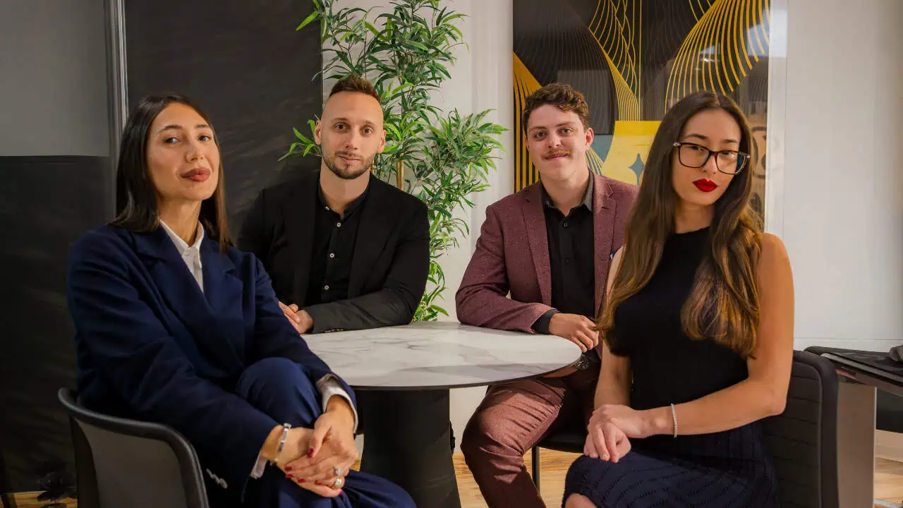 Dream Writers team discussing projects around a meeting table